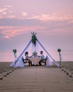 Romantic dinner on the beach, honemoon dinner on the beach during sunset Thailand, valentine setting Royalty Free Stock Photo