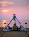 Romantic dinner on the beach, honemoon dinner on the beach during sunset Thailand, valentine setting Royalty Free Stock Photo