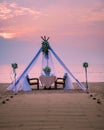 Romantic dinner on the beach, honemoon dinner on the beach during sunset Thailand, valentine setting Royalty Free Stock Photo