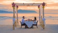 Romantic dinner on the beach in Phuket Thailand, couple man and woman having dinner on the beach Royalty Free Stock Photo