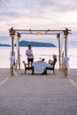 Romantic dinner on the beach in Phuket Thailand, couple man and woman mid age Asian woman and European man having a Royalty Free Stock Photo