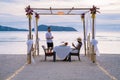 Romantic dinner on the beach in Phuket Thailand, couple man and woman mid age Asian woman and European man having a Royalty Free Stock Photo