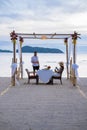 Romantic dinner on the beach in Phuket Thailand, couple man and woman mid age Asian woman and European man having a Royalty Free Stock Photo