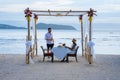 Romantic dinner on the beach in Phuket Thailand, couple man and woman mid age Asian woman and European man having a Royalty Free Stock Photo