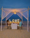 Romantic dinner on the beach in Phuket Thailand, couple man and woman having dinner on the beach Royalty Free Stock Photo