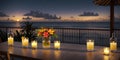 Romantic dinner on the beach by the sea. Wooden table with candles and flowers in a vase on the beach. .Candles and flowers on a Royalty Free Stock Photo