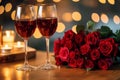 Romantic Dinner. Bouquet of flowers lying on the table, selective focus on bunch of roses, two glasses of red wine and candles on Royalty Free Stock Photo