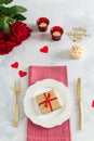 Romantic dinner concept. St Valentine`s day or proposal background. Romantic gift on the white plate on restaurant table with Royalty Free Stock Photo