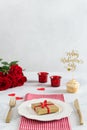 Romantic dinner concept. St Valentine`s day or proposal background. Romantic gift on the white plate on restaurant table with Royalty Free Stock Photo