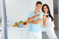 Romantic dinner. Couple drinking wine in the kitchen. Young peop Royalty Free Stock Photo