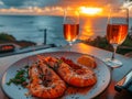 Romantic Dinner Overlooking Sunset at Beach with Grilled Shrimp and Wine Glasses Royalty Free Stock Photo