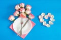 Romantic dinner: plate, cutlery and roses on blue background. served plate with napkin and rose, table setting with roses on plate