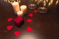 Romantic dinner scene at home: candles, box with a jewel and two glasses of wine. Royalty Free Stock Photo