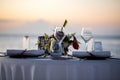 Romantic dinner setting on the beach at sunset. Royalty Free Stock Photo