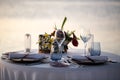 Romantic dinner setting on the beach at sunset. Royalty Free Stock Photo