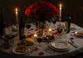 A romantic dinner setting features a round table covered with a white tablecloth and Royalty Free Stock Photo