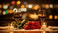 Romantic dinner setting with two glasses of red wine and red roses. Candlelight date night with bokeh city lights background. Royalty Free Stock Photo