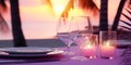 Romantic dinner at sunset on a tropical palm beach, in a restaurant overlooking the sea. Summer love, romantic date on vacation. Royalty Free Stock Photo