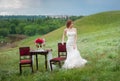 romantic dinner table bride is leaning on chair