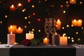 Romantic dinner table setting with burning candles