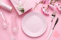 Romantic dinner, table setting on Valentine`s Day. Dating concept, love. Spring flowers, empty plate, glasses, champagne, gift bo Royalty Free Stock Photo