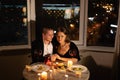 romantic dinner for two with candles, date by candlelight with wine, couple in love on valentine's day, man and woman Royalty Free Stock Photo