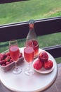 Romantic dinner for two lovers at sunset. A bottle of rose wine, two glasses and fruit on the table Royalty Free Stock Photo