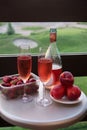 Romantic dinner for two lovers at sunset. A bottle of rose wine, two glasses and fruit on the table Royalty Free Stock Photo