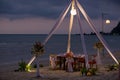 Romantic dinning table on the beach . Table setting at a luxury wedding and Beautiful flowers on the table. Royalty Free Stock Photo