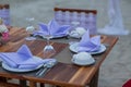 Romantic dinning table on the beach . Table setting at a luxury wedding and Beautiful flowers on the table. Royalty Free Stock Photo