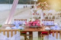 Romantic dinning table on the beach . Table setting at a luxury wedding and Beautiful flowers on the table. Royalty Free Stock Photo