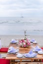 Romantic dinning table on the beach . Table setting at a luxury wedding and Beautiful flowers on the table. Royalty Free Stock Photo