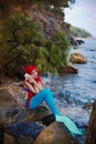 Romantic dreamer girl in mermaid costume on sea side