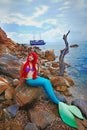 Romantic dreamer girl in mermaid costume on sea side