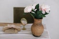 Romantic dressing table with a bouquet of peonies in a vase and a mirror. Bedroom interior in the vintage style. Boudoir. Royalty Free Stock Photo