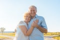 Romantic elderly couple enjoying health and nature in a sunny da