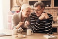 Romantic elderly couple enjoying morning coffee in kitchen together