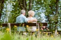 Romantic elderly couple sitting together on a bench in a tranqui