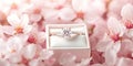 Romantic engagement ring box on cherry blossom bed for wedding proposal themes Royalty Free Stock Photo