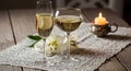 Romantic evening ambiance two glasses of white wine and candlelight on rustic table Royalty Free Stock Photo