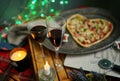 Romantic evening with candles, wine, heart shaped Pizza. Love. St Valentin's Day. Holidays celebration. Royalty Free Stock Photo