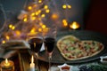 Romantic evening with champagne, candles, heart shaped Pizza. Love. Celebrate holidays. Cozy. Home related Royalty Free Stock Photo