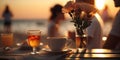 romantic relaxing sunset beach cafe resort ,cup of coffee ,glass of wine,weet cake and flowers on table Royalty Free Stock Photo