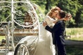 Romantic fairy-tale wedding couple bride and groom kissing in ma