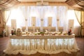 Romantic fairytale catered white table at wedding reception with