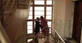 Romantic farewell of lovers on the steps of an old apartment building Royalty Free Stock Photo