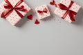 Romantic flat lay composition with gift boxes wrapped red ribbon bows