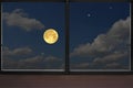 Romantic full moon in blue sky in the window view Royalty Free Stock Photo