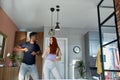 Romantic funny couple dancing at home