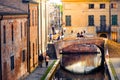 Romantic getaways in italy warm tone lights at sunset over red bricks old buildings and bridge on the canal of Comacchio Ferrara Royalty Free Stock Photo